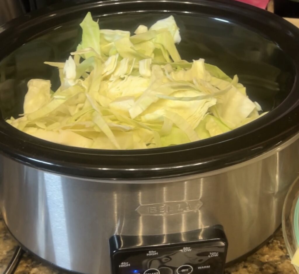 Sliced green cabbage in a slow cooker