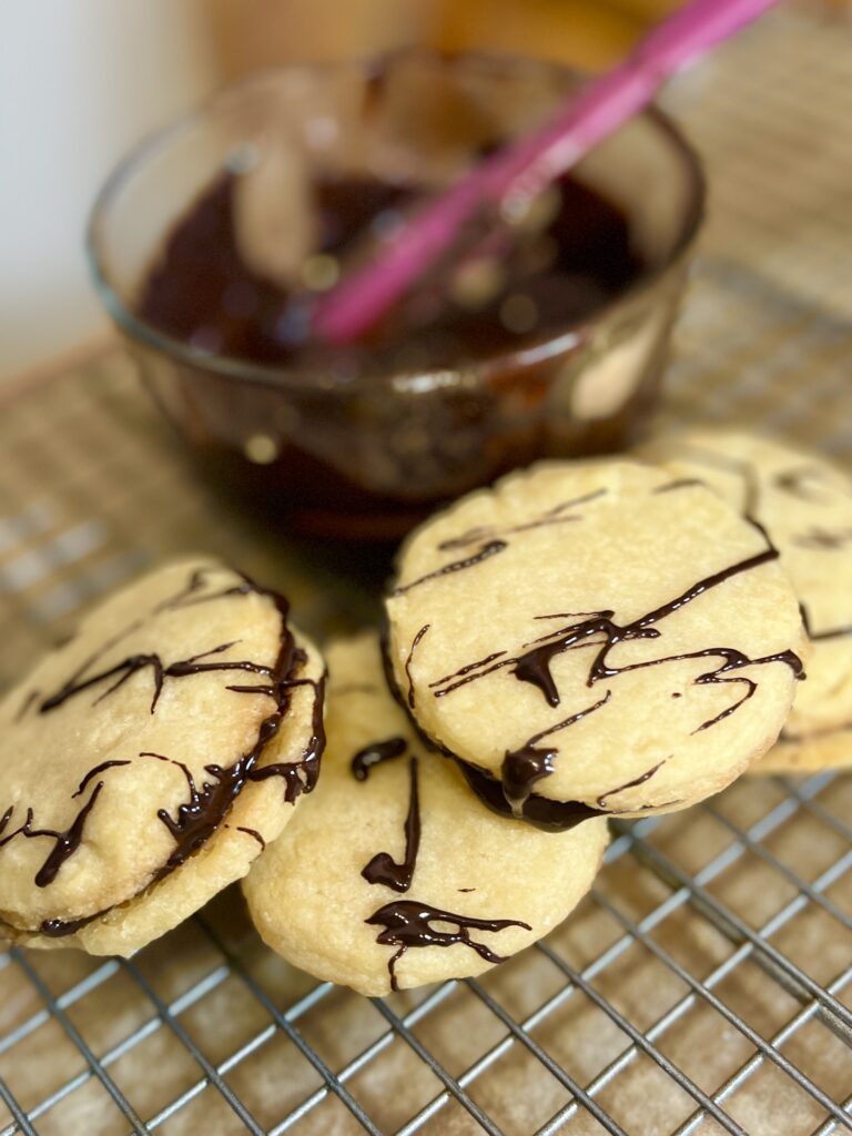 Chocolate Hummus Cookies next to a bowl of chocolate hummus with a pink spatula