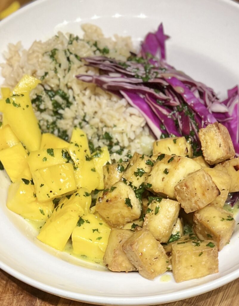 Bowl of rice, spicy tofu, red cabbage and mango